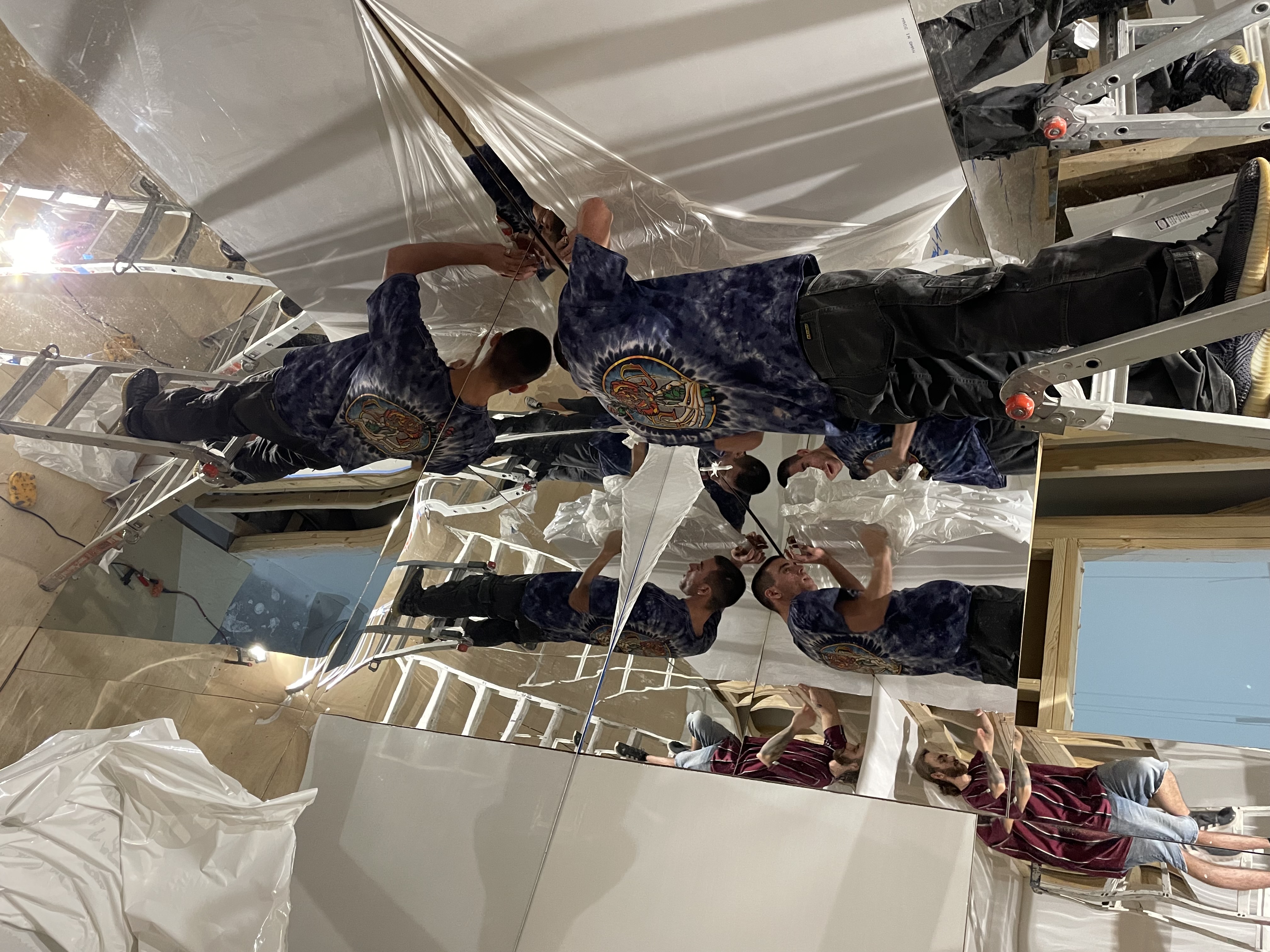 Art of Banksy exhibit - Workers installing large mirrored panels