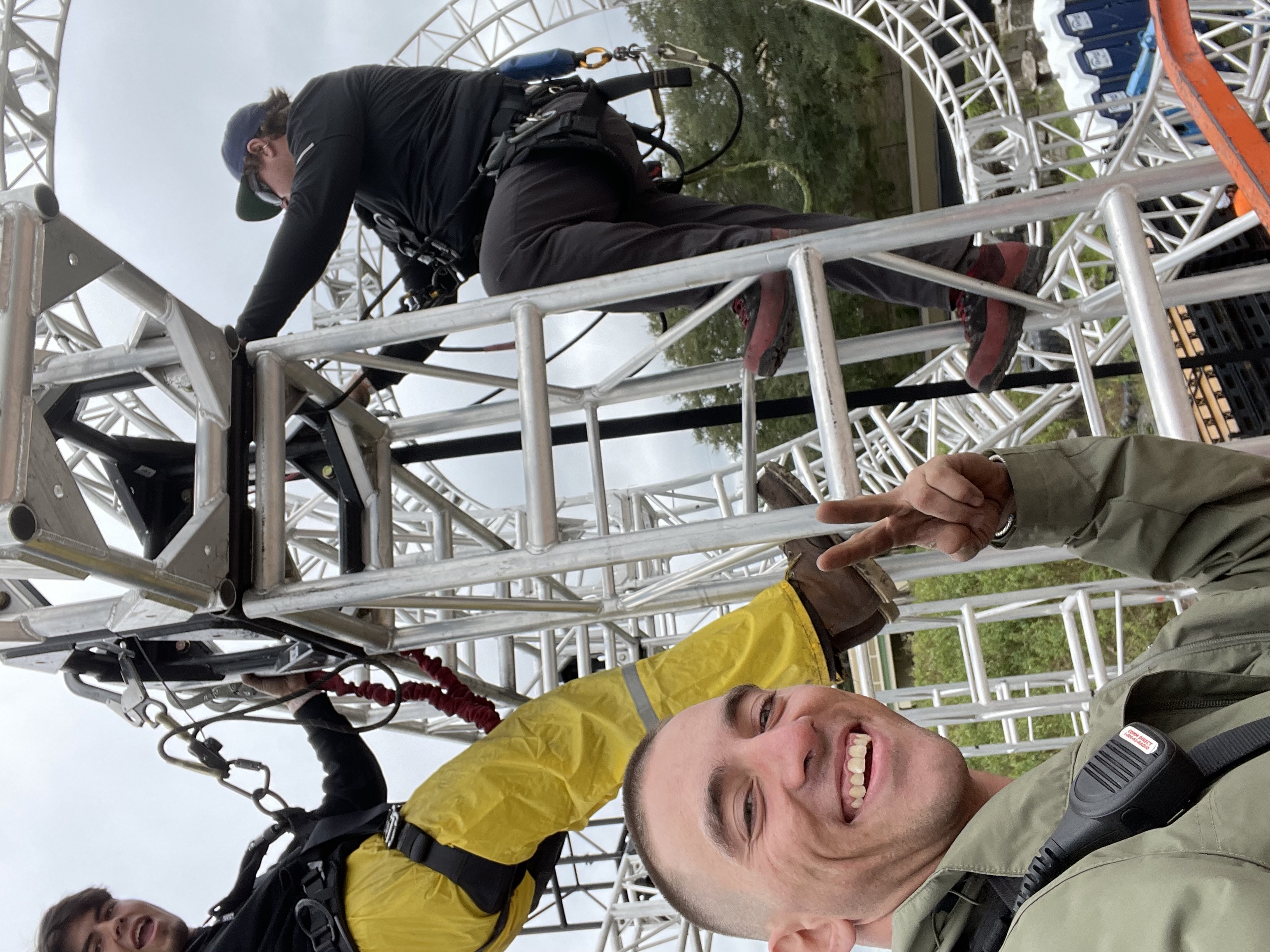 Dillon Bolognino selfie with crew rigging a structure